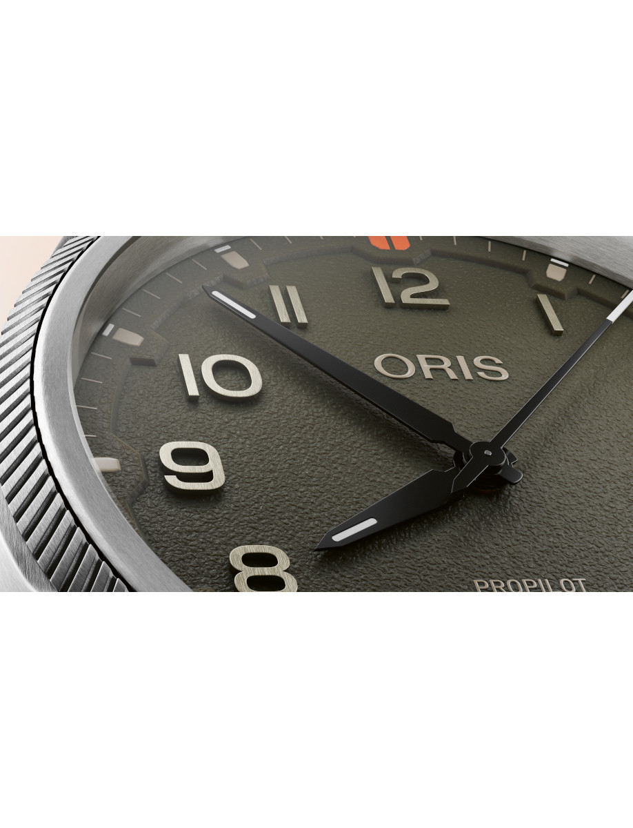 Close view of Oris wristwatch with stainless steel case, and moss green dial.