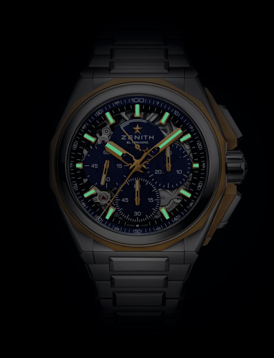 Night view of Zenith wristwatch with 18k microblasted yellow gold & polished steel case, Lapis Lazuli dial, and stainless steel bracelet.