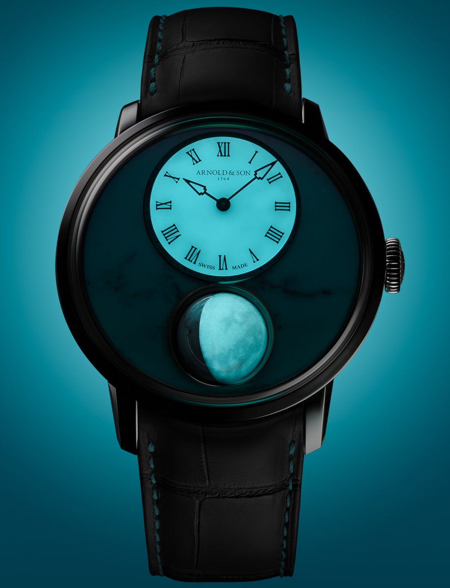 Night view of Arnold&Son wristwatch with stainless steel case, and turquoise alligator leather strap.