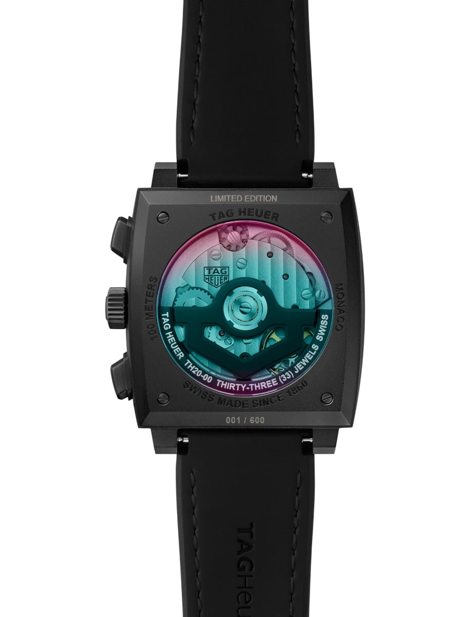 Back view of TAG Heuer wristwatch with titanium DLC-coated case, open case back, and black rubber & leather strap.