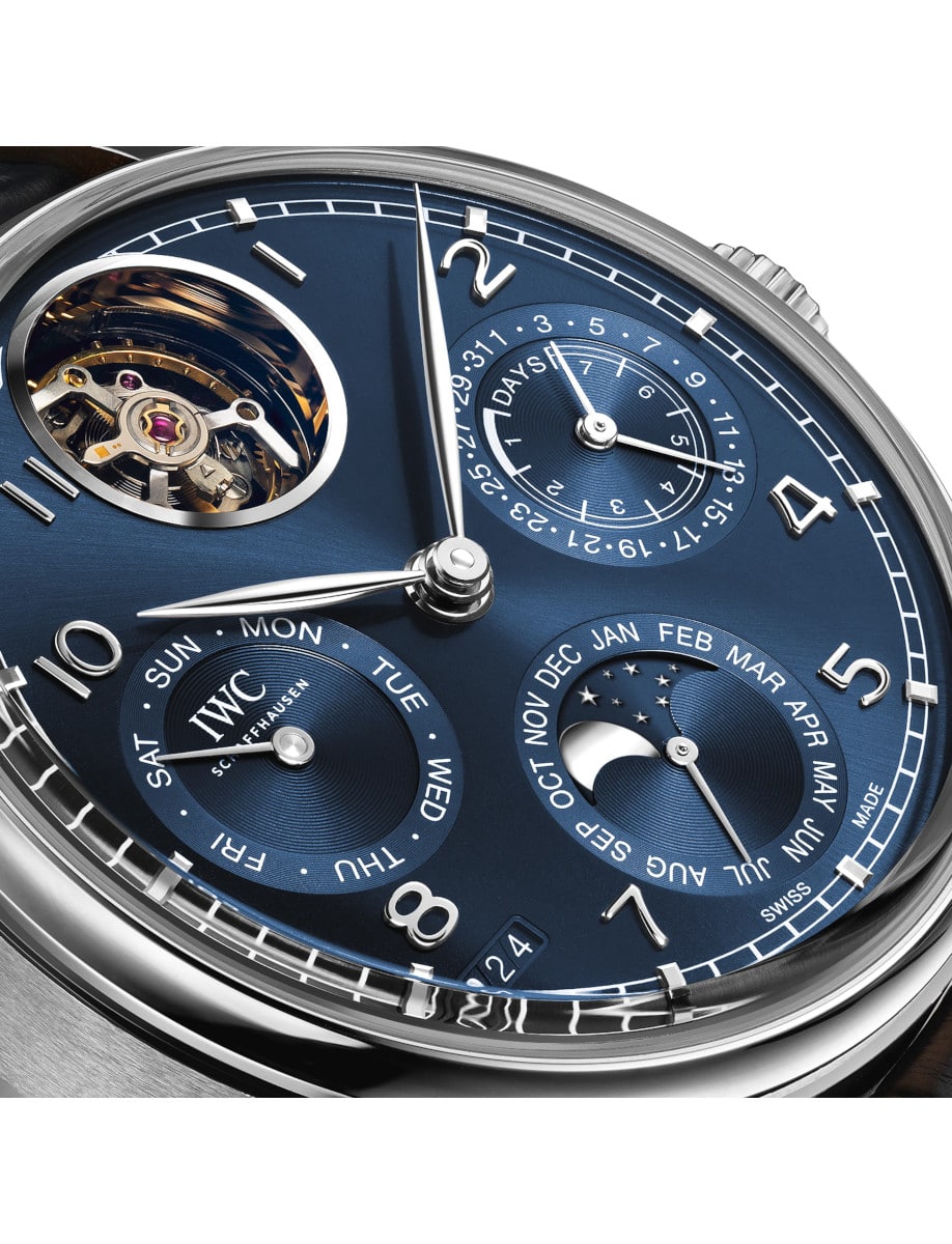 Close view of IWC wristwatch with platinum case, and blue dial.