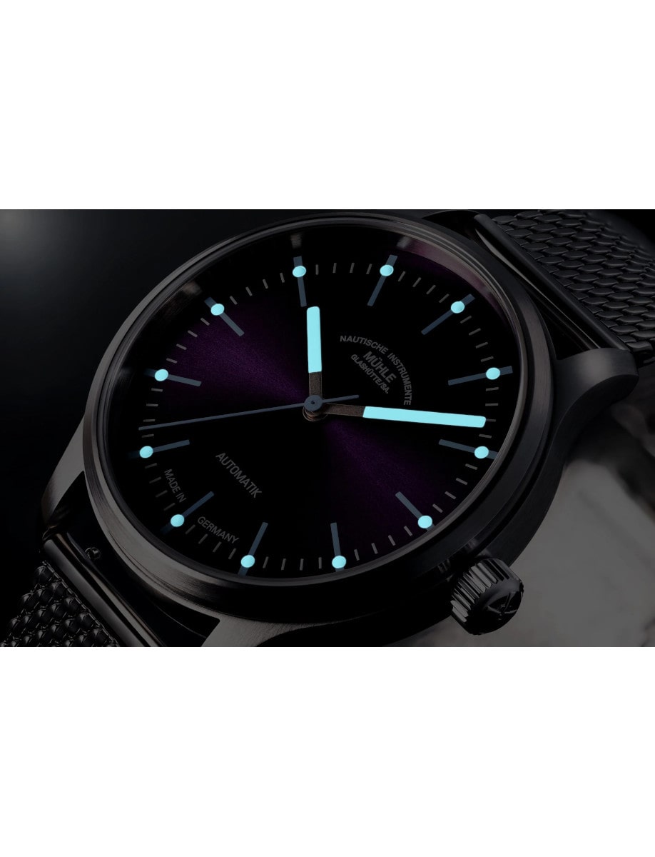 Night view of Muhle Glashutte wristwatch with stainless steel, violet dial, and grey leather strap.