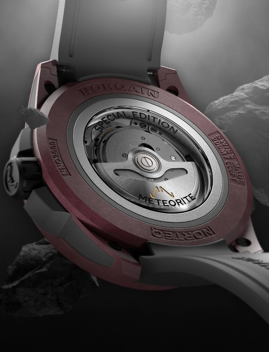 Back view of Norqain wristwatch with sandblasted titanium case, open case back, and Integrated anthracite rubber strap.