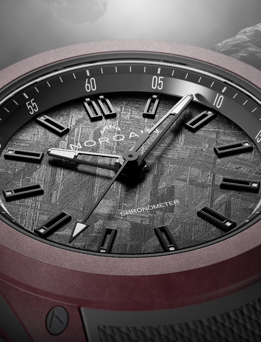 Close view of Norqain wristwatch with sandblasted titanium case, anthracite iron meteorite dial, and Integrated anthracite rubber strap.