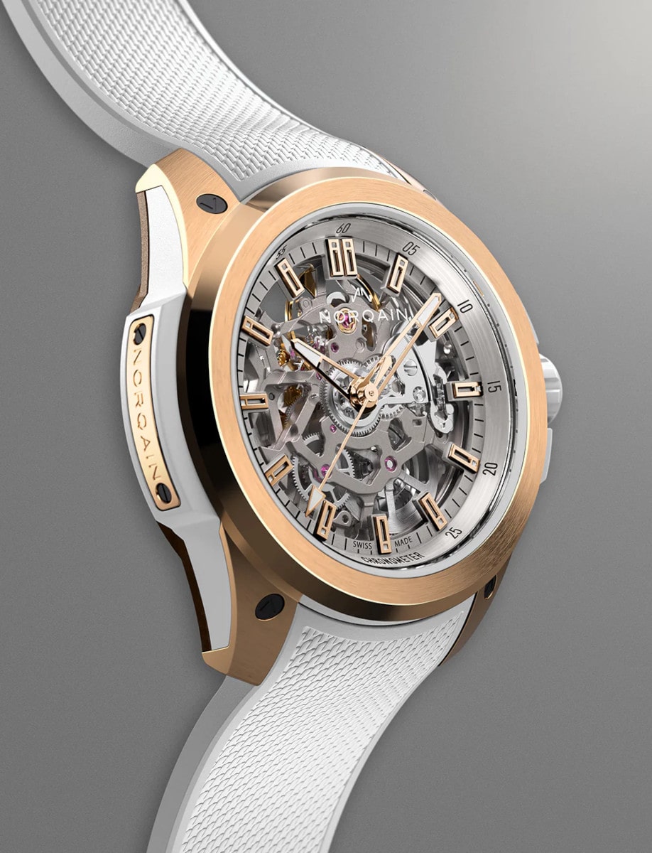 Right side view of Norqain wristwatch with red gold case, white rubber strap, and skeleton dial.