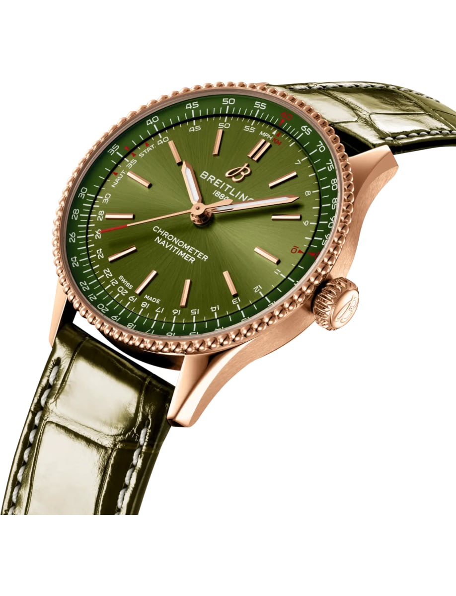 Side view of Breitling wristwatch with 18k red gold case, green dial and alligator leather strap