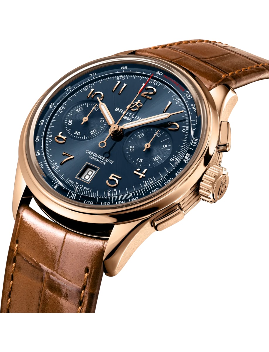 Side view of Breitling wristwatch with 18k red gold case, blue dial and alligator leather strap