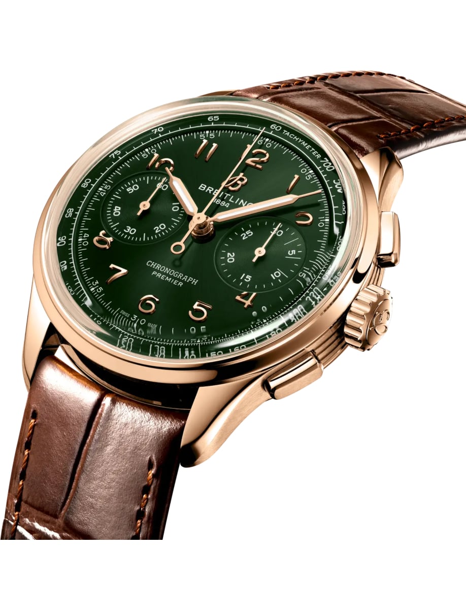 Side view of Breitling wristwatch with 18k red gold case, green dial and alligator leather strap
