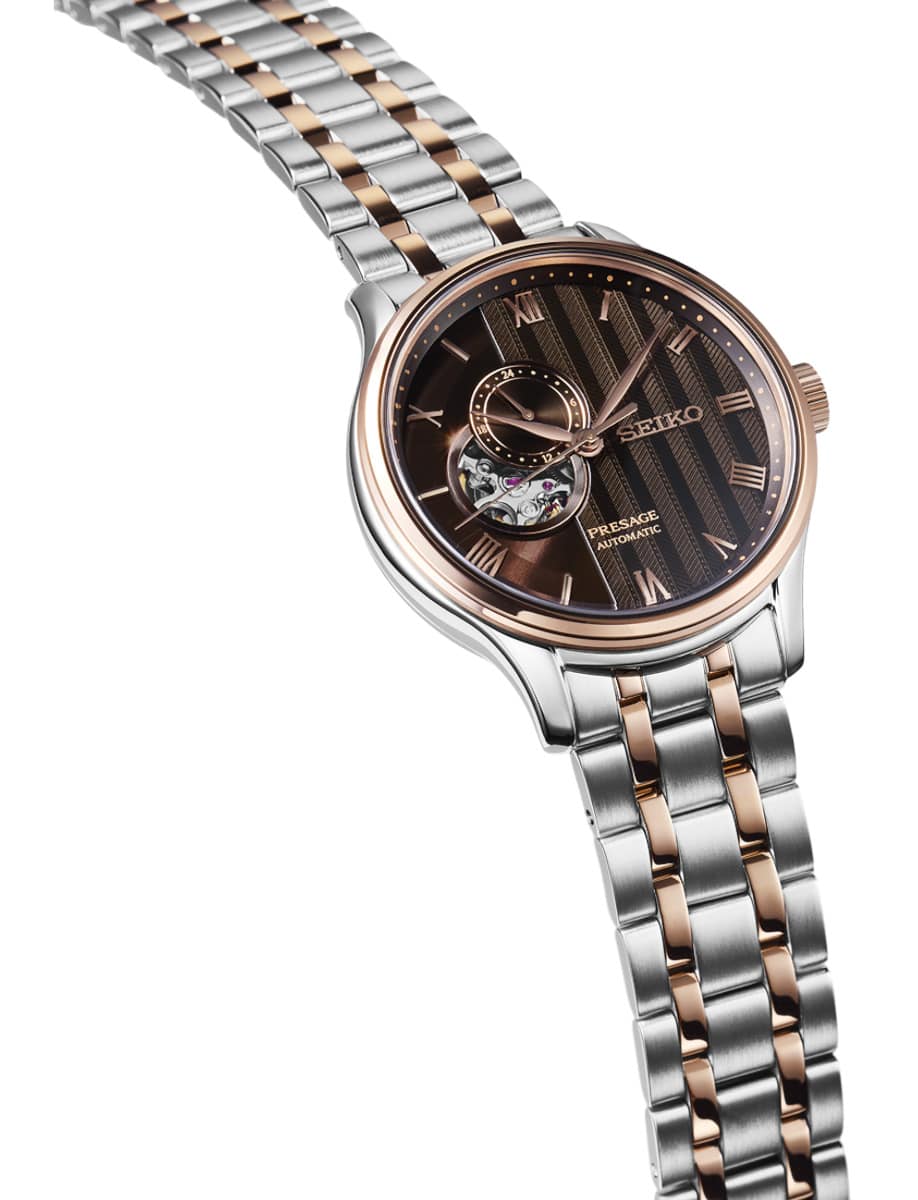 Side view of Seiko wristwatch with stainless steel case and bracelet and black dial