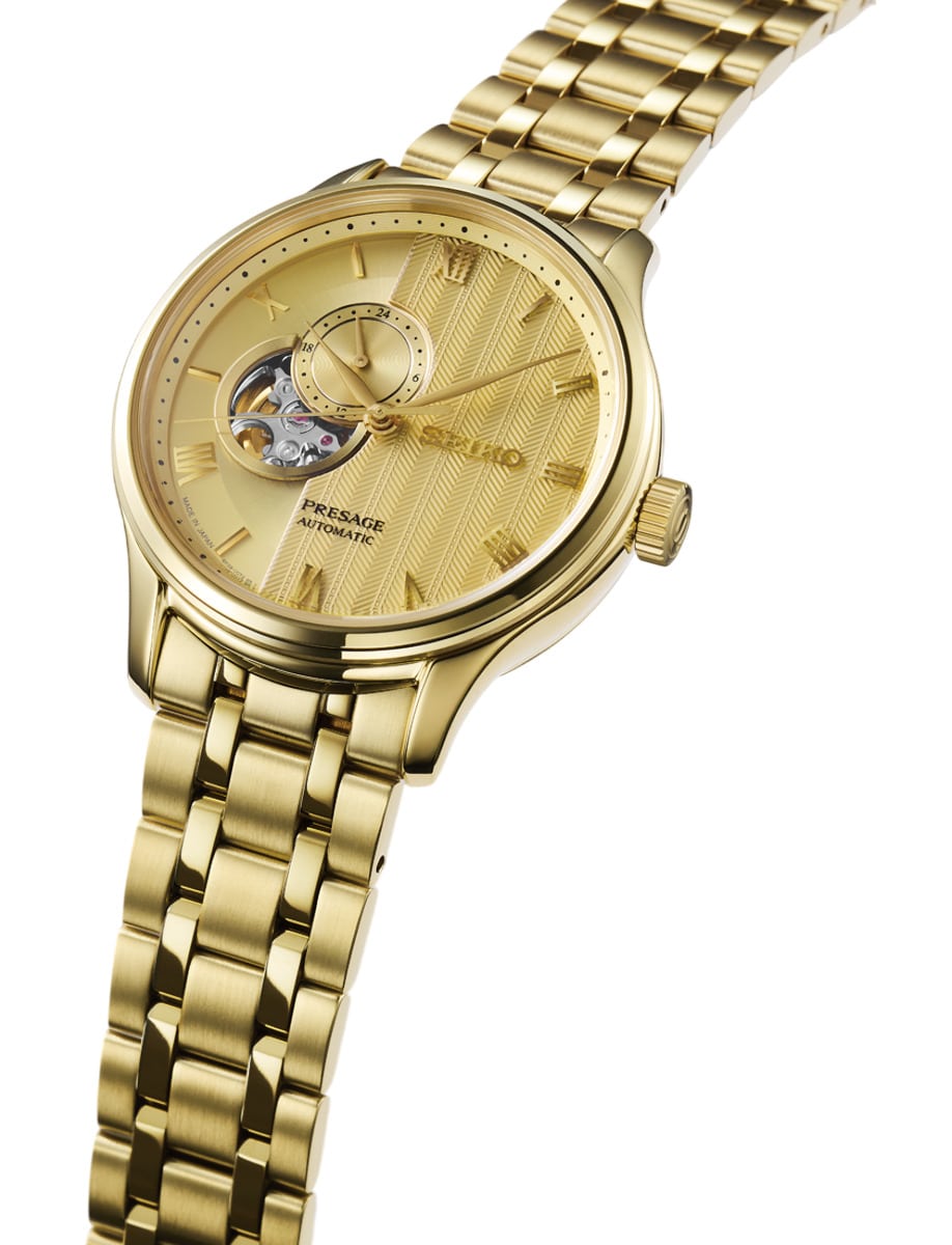 Side view of Seiko wristwatch with stainless steel case and bracelet and gold tone dial