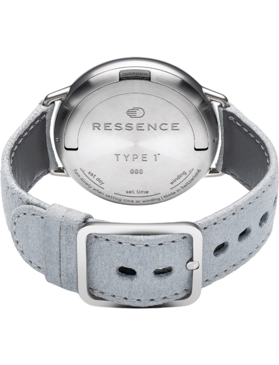Ressence wristwatch with grade 5 titanium case, solid case back, and leather strap.