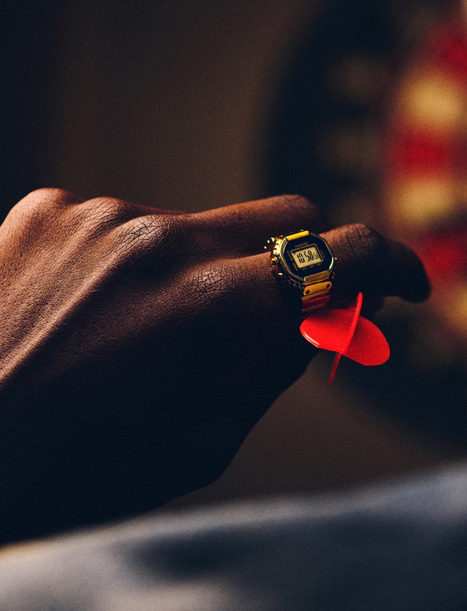 Lifestyle image of Casio ring watch in gold ion plated stainless steel and digital display.