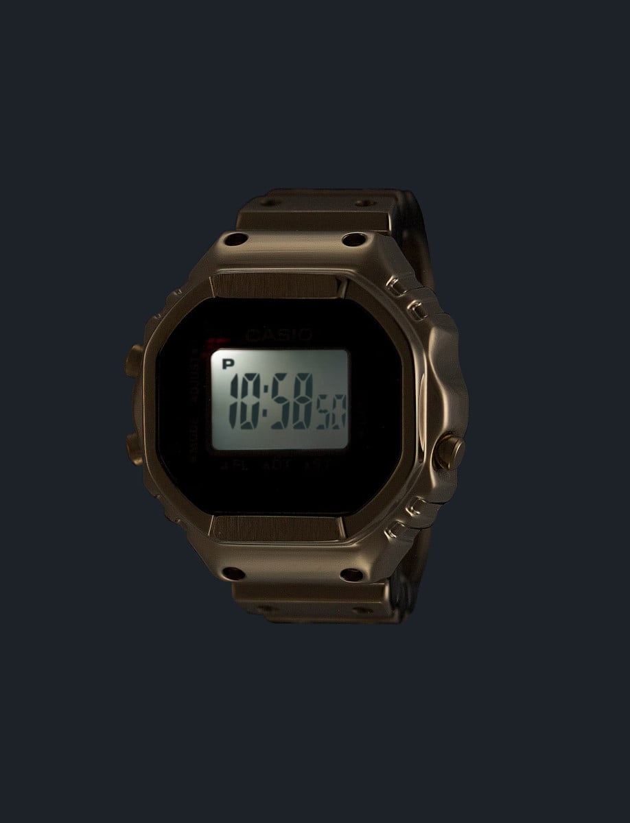 Casio ring watch in gold ion plated stainless steel and digital display showing LED light.