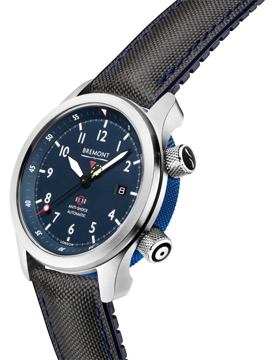 Side view of Bremont wristwatch with stainless steel case, blue dial, and blue leather strap.