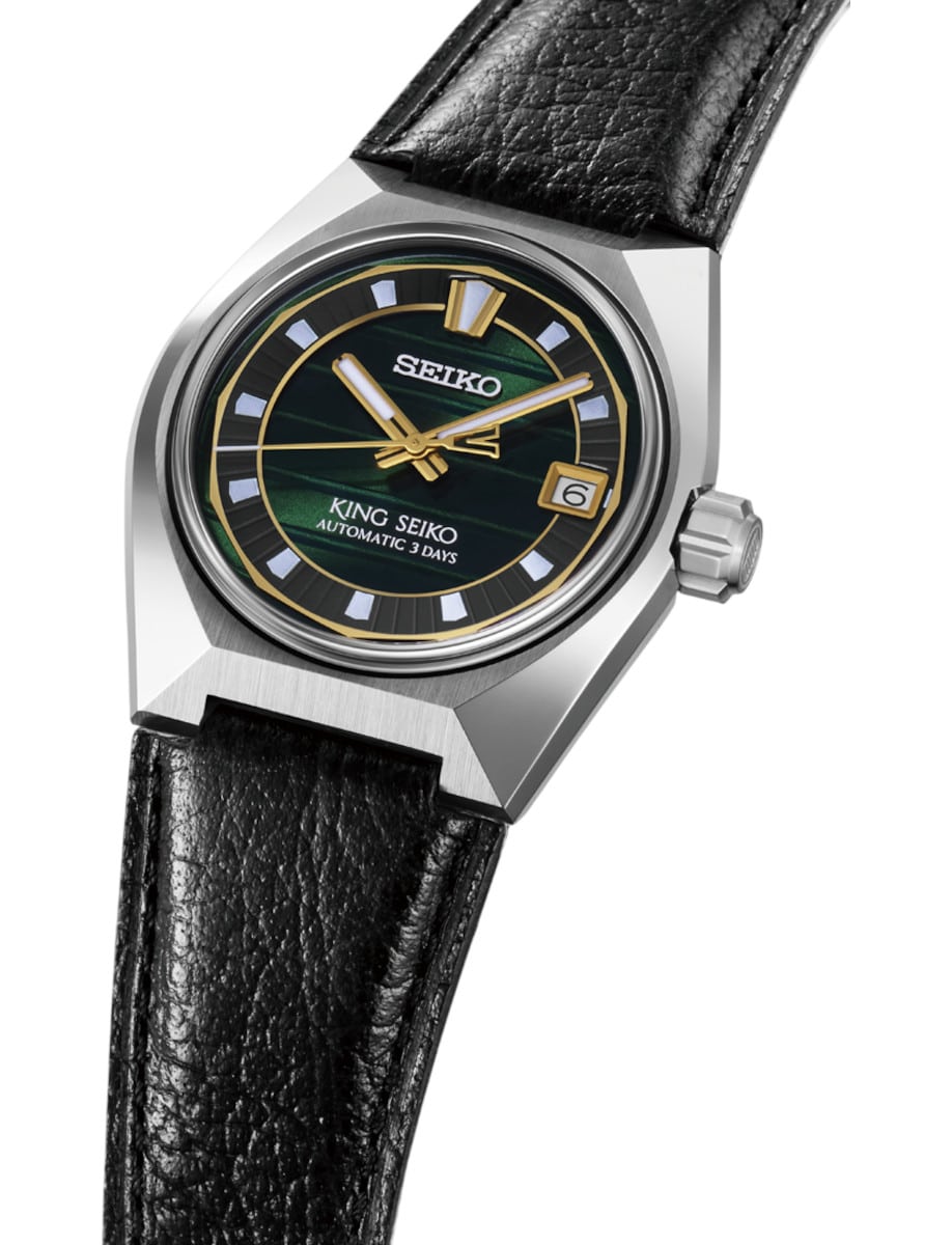 Side view of Seiko wristwatch with stainless steel case, green dial, and black cow leather strap.
