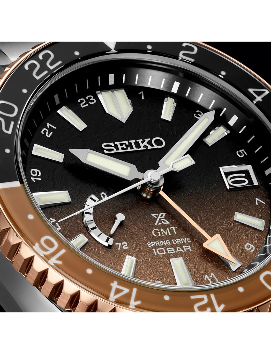 Close view of Seiko Luxe wristwatch with titanium case, and gradient black to brown dial.