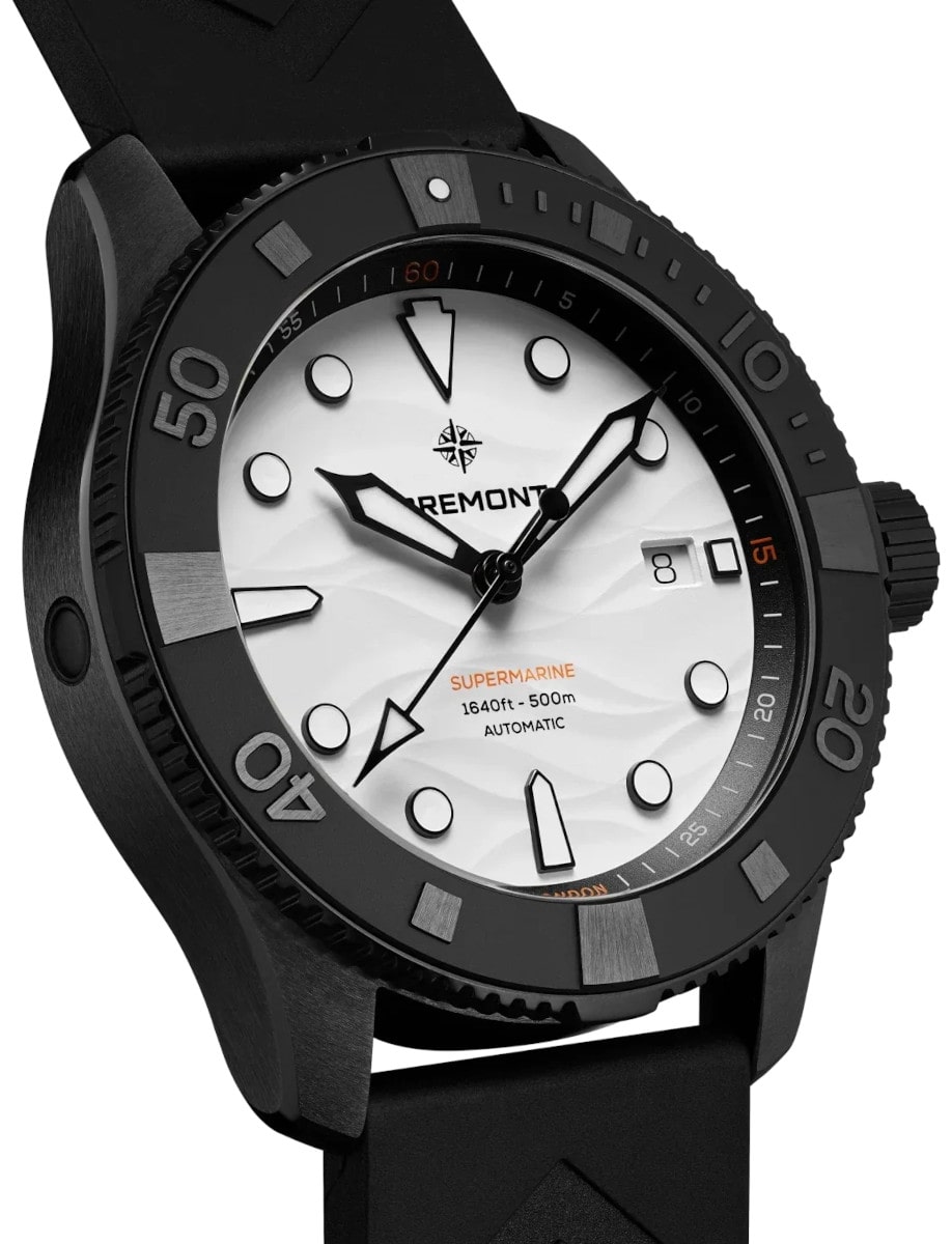 Side view of Bremont wristwatch with ceramic and titanium case, white dial, and black rubber chevron strap.