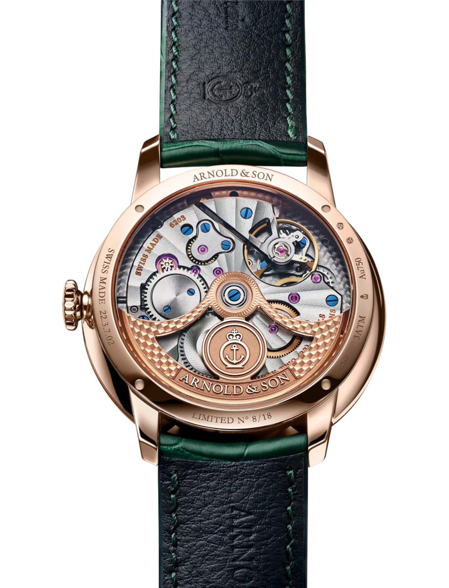 Back view of Arnold&Son wristwatch with 18k red gold 5N case, sapphire crystal case back with an anti-reflecting coating, and Cornish green alligator leather strap.