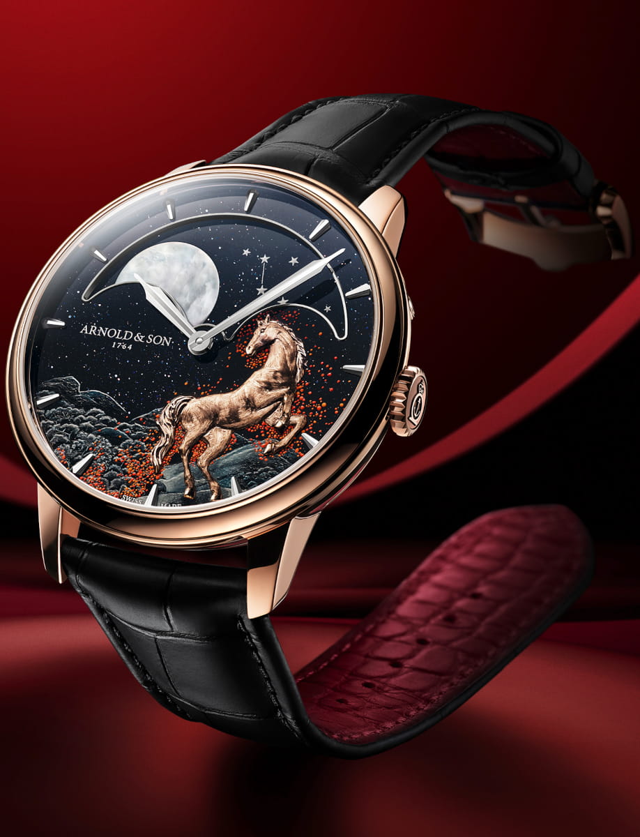 Side view of Arnold&Son wristwatch with 18k red gold case, black aventurine dial, and black leather strap.