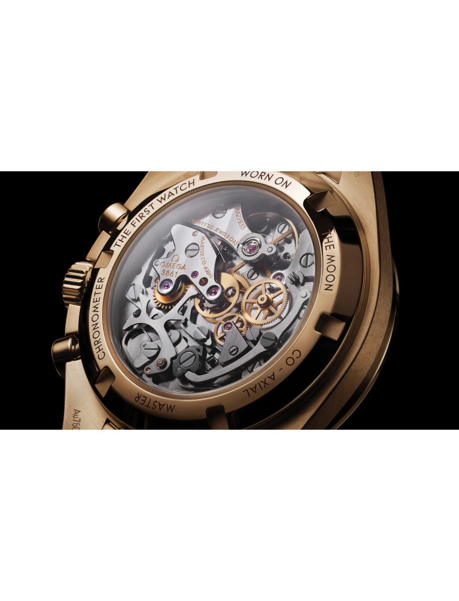 Close-up of a gold luxury watch movement visible through a transparent case back, showing gears and jewels.