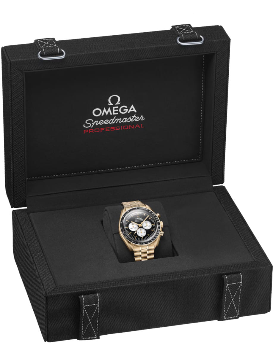 Omega Speedmaster Professional gold watch displayed in an open black presentation case with padding and branded interior.