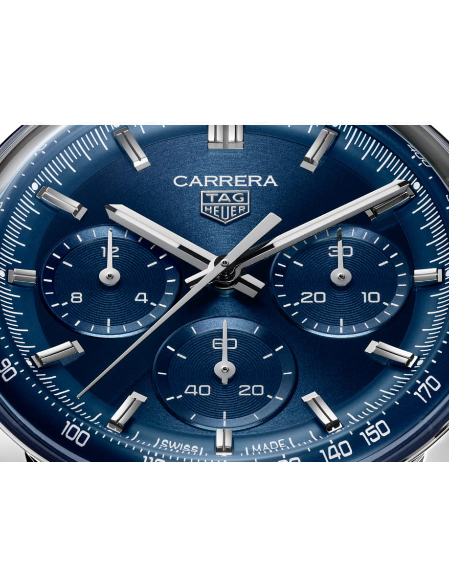 Close view of Tag Heuer wristwatch with stainless steel case, and blue dial.