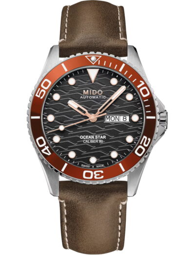 Mido wristwatch with stainless steel case, black dial, and brown leather strap.