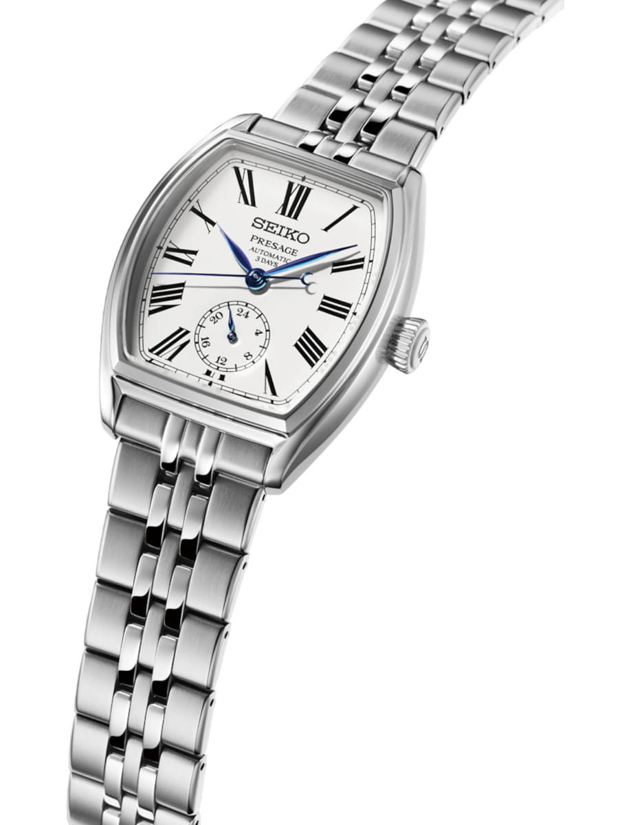 Side view of Seiko wristwatch with stainless steel case and bracelet, and white enamel dial.