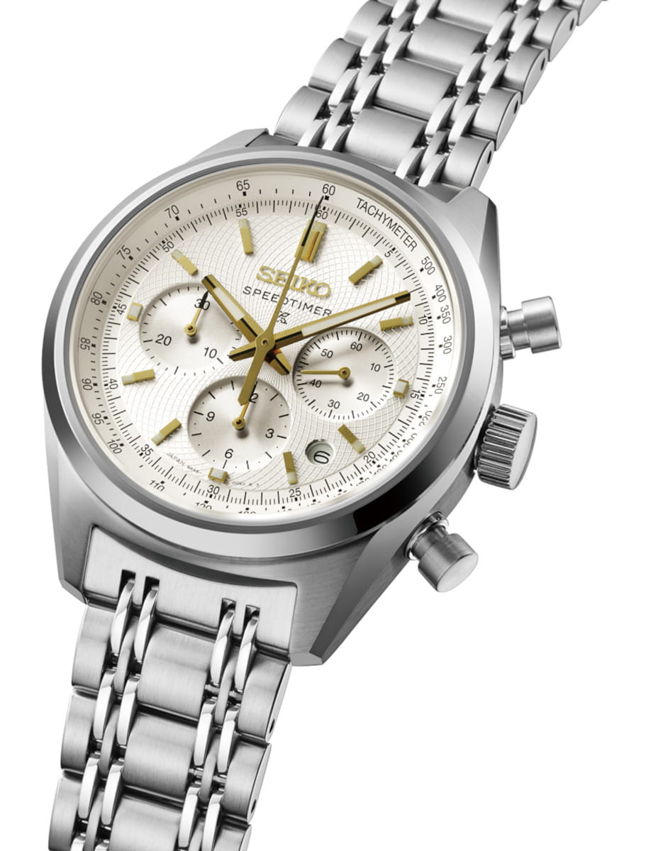 Side view of Seiko wristwatch with stainless steel case and bracelet, white dial with gold-colored accents.