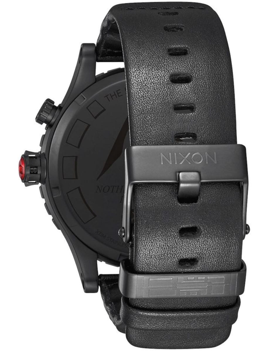 Back view of Nixon wristwatch with stainless steel case and black leather strap.