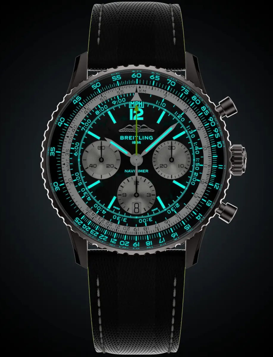 Night view of Breitling Navtimer wristwatch with titanium case, black dial, and anthracite calfskin leather strap.