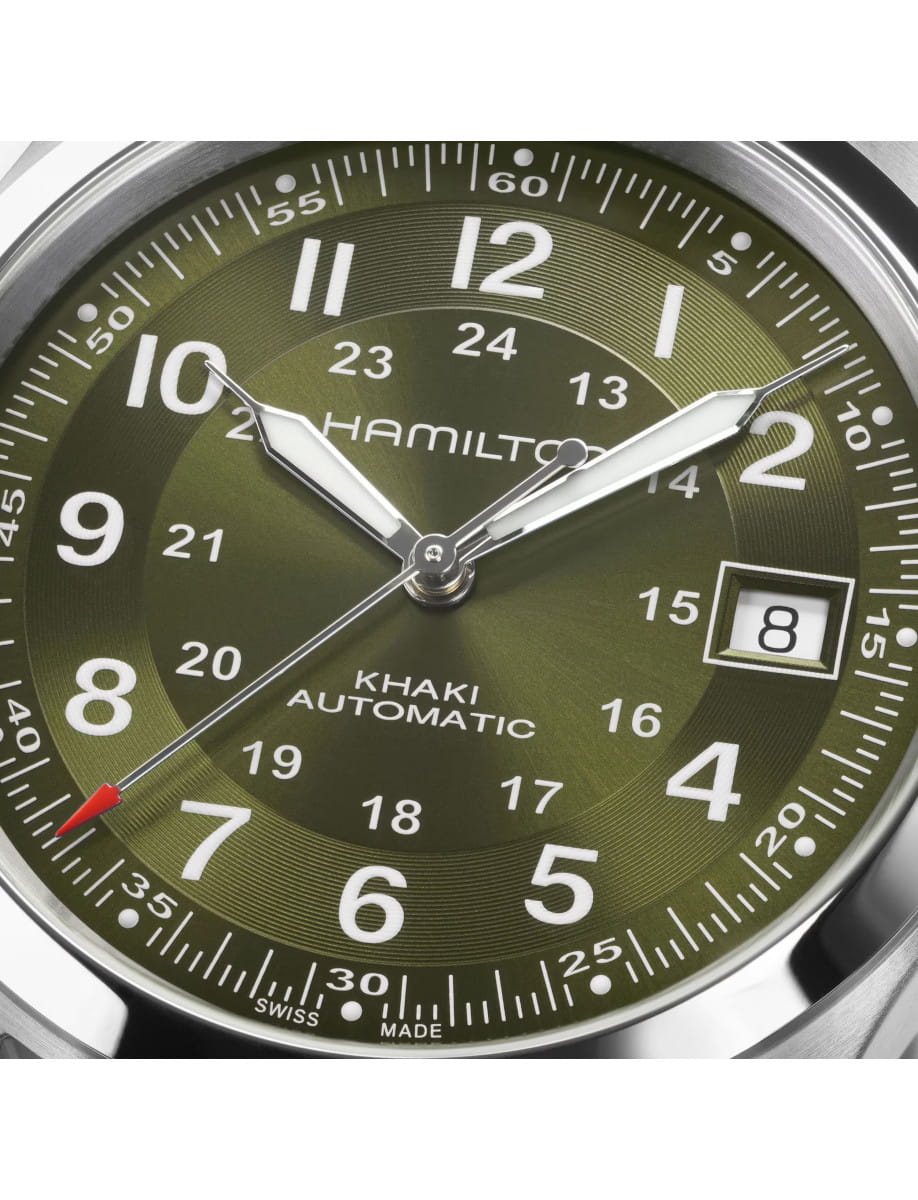 Close view of Hamilton Khaki Field wristwatch with stainless steel case, green dial, and black textile strap.