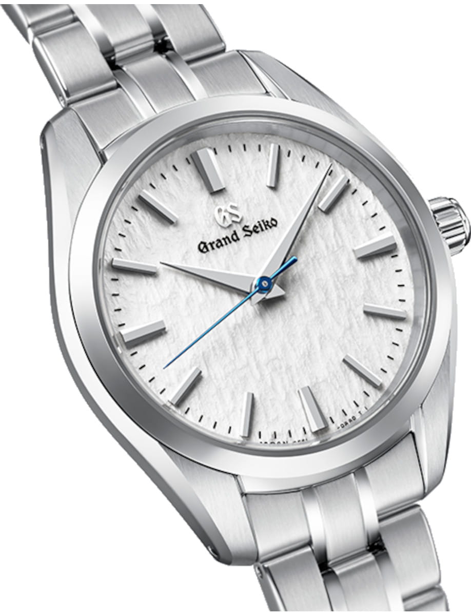 Side view of Grand Seiko wristwatch with stainless steel case and bracelet, and pure white dial.