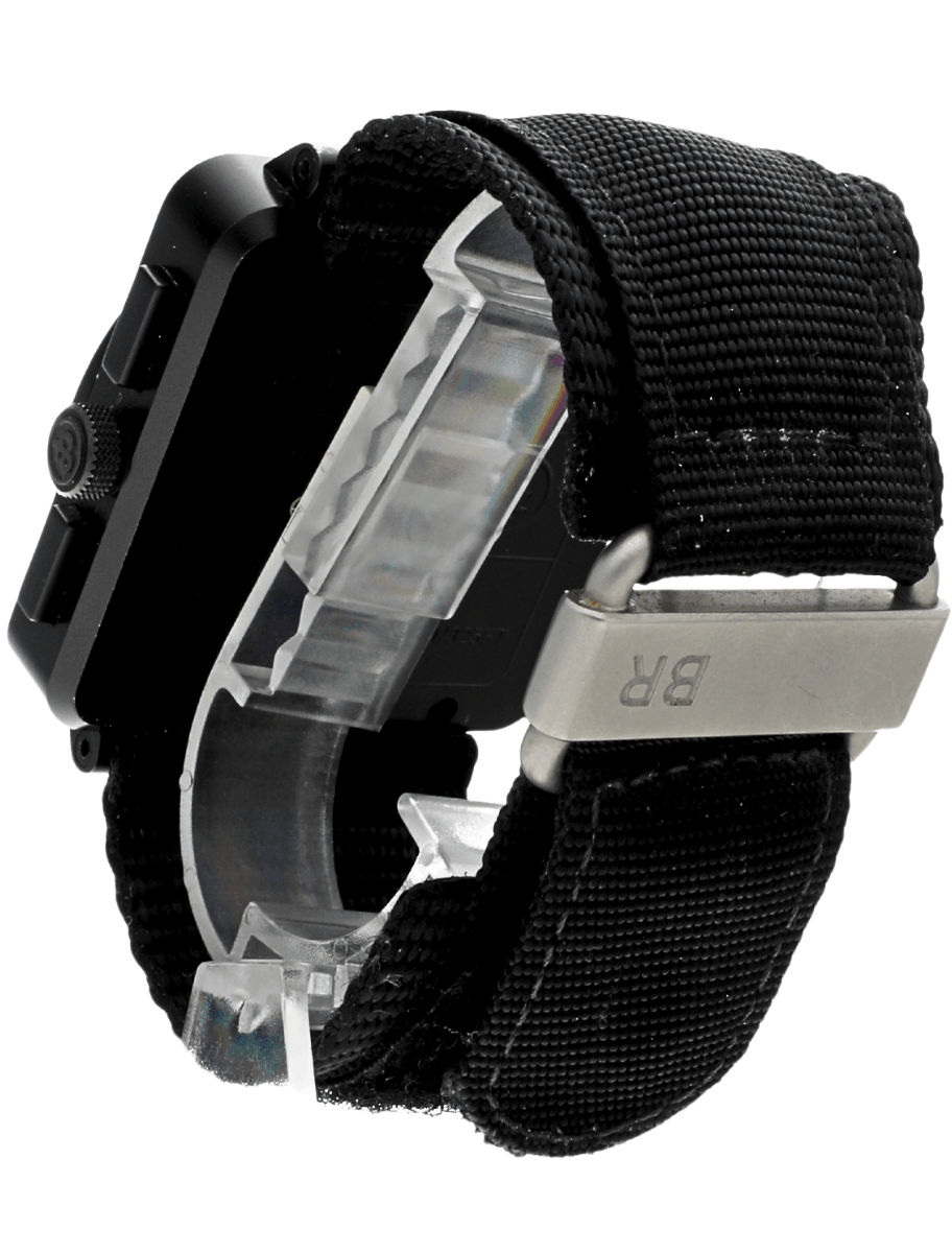 Back left side view of pre-owned Bell&Ross wristwatch with PVD coated stainless steel case, black dial, and black fabric strap.