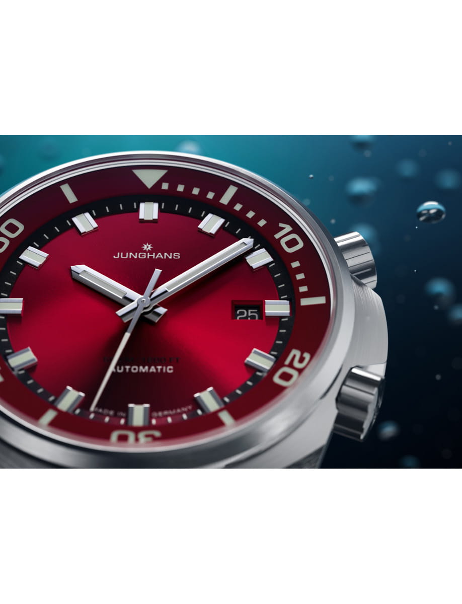 Side view of Junghans wristwatch with stainless steel case and bracelet, and red with sunray brush dial.