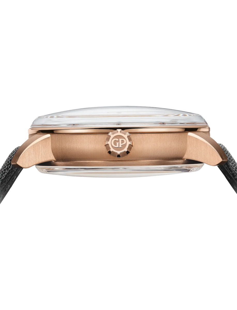 Side view of Girard-Perregaux wristwatch with pink gold case, openworked dial, and black rubber strap.