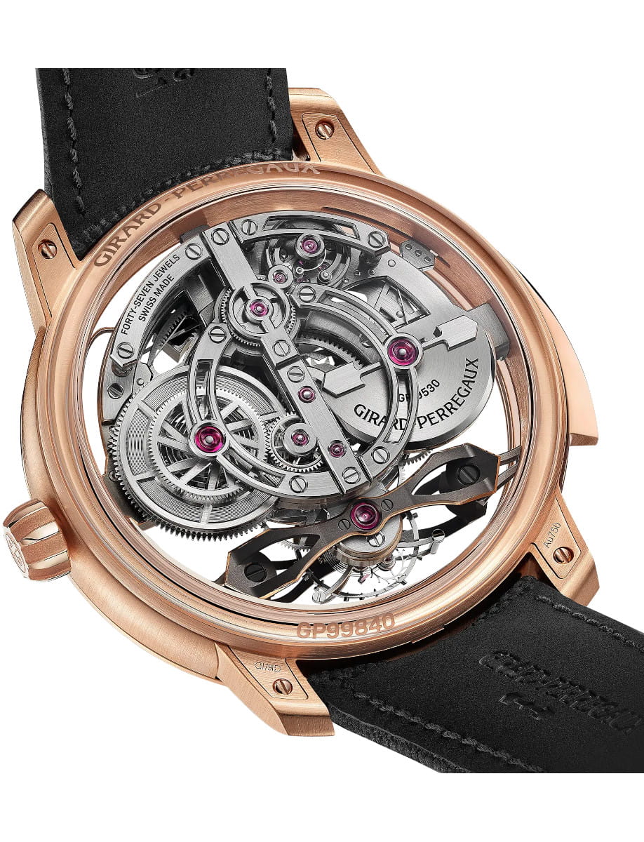 Back view of Girard-Perregaux wristwatch with pink gold case, openworked dial, and black rubber strap.