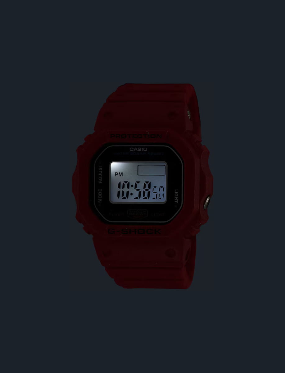 Night view of G-Shock wristwatch with red resin and bio-based resin case and bracelet, and digital display.