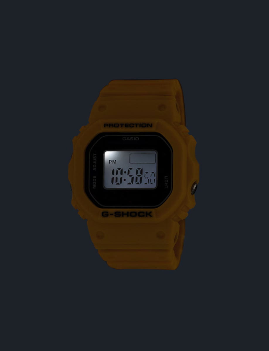 Night view of G-Shock wristwatch with yellow resin and bio-based resin case and bracelet, and digital display.