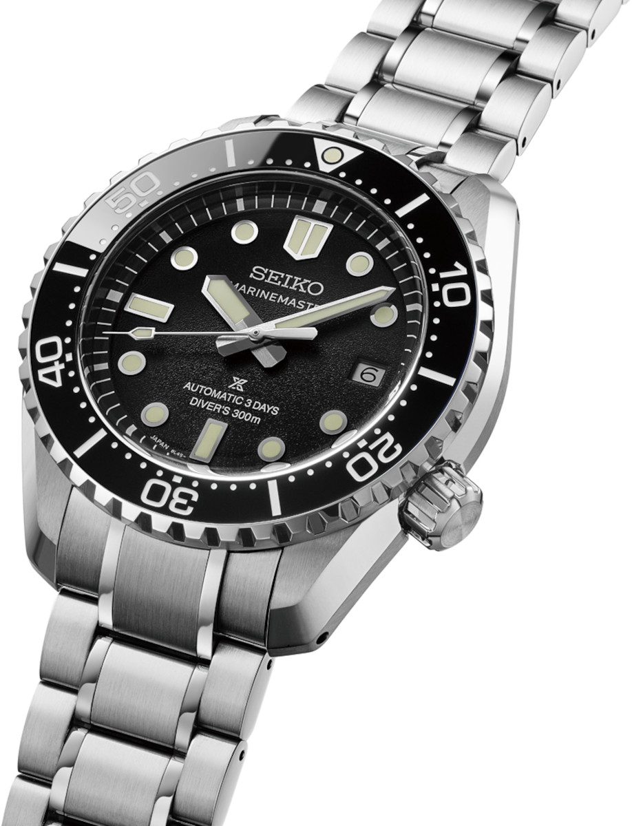 Side view of Seiko Prospex wristwatch with stainless steel case and bracelet, and black dial.