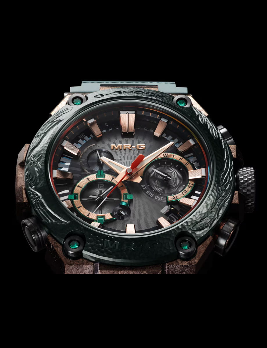 Front view of G-Shock wristwatch with titanium case, black dial, and dark green Dura Soft rubber strap.