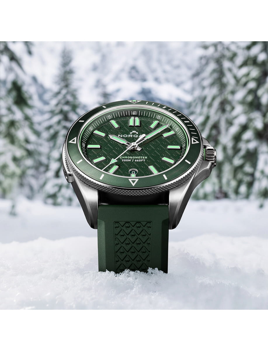Front view of Norqain wristwatch with stainless steel case, green dial and dark green rubber strap