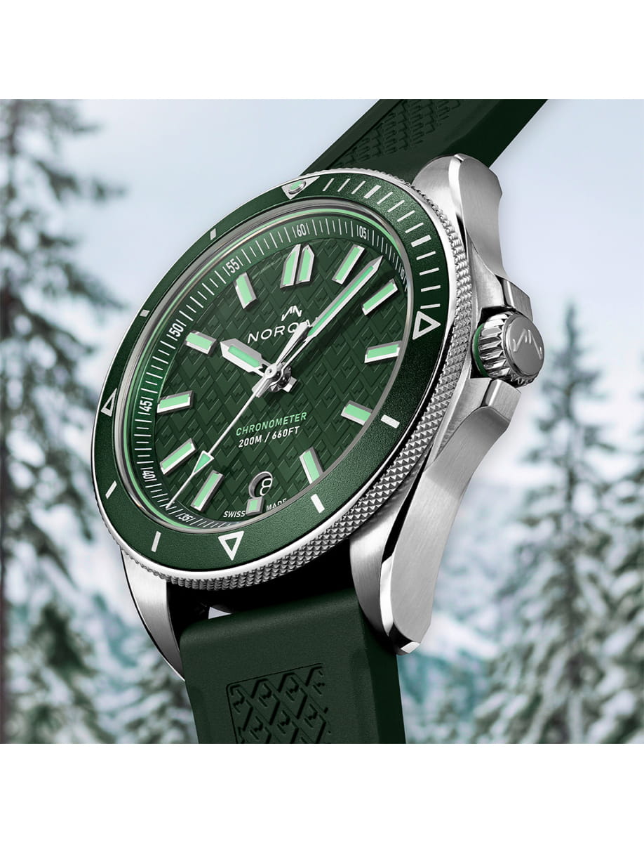 Side view of Norqain wristwatch with stainless steel case, green dial and dark green rubber strap