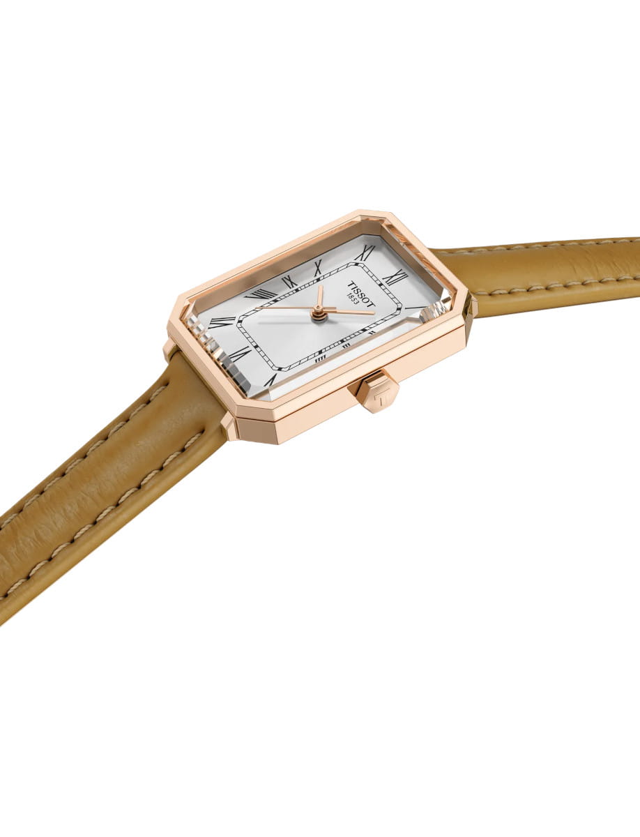 Side view of Tissot wristwatch with stainless steel case, silver dial, and light brown embossed cow leather.