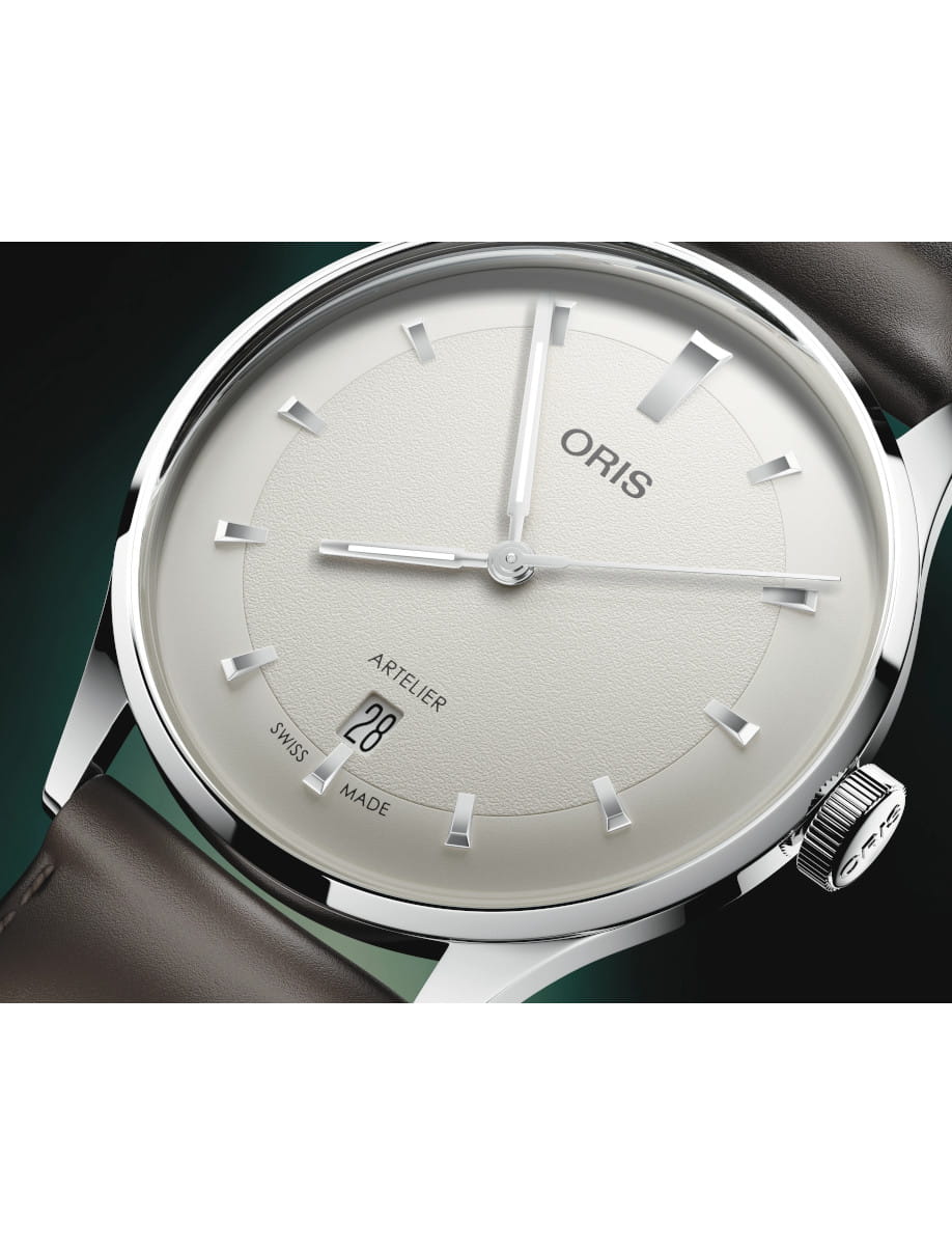 Close view of Oris Artelier Date wristwatch with stainless steel case, white dial, and dark brown leather strap.