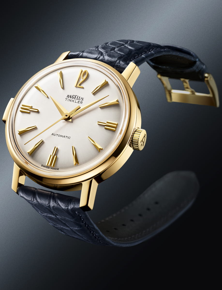 Side view of Angelus Tinkler wristwatch with 18k yellow gold, white dial, and ink blue alligator flank leather.