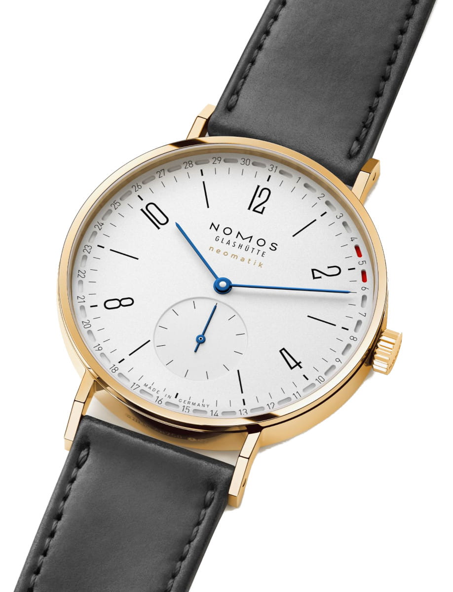 Side view of Nomos Tangente gold neomatik 38 Update wristwatch with 18k gold case, white silver-plated dial, and black Horween Genuine Shell Cordovan strap.