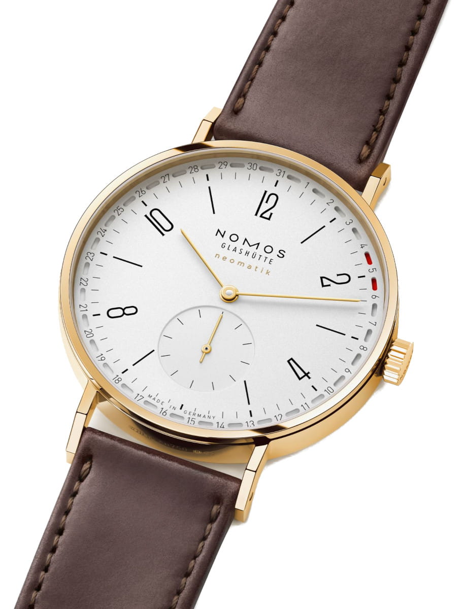 Side view of Nomos Tangente gold neomatik 38 Update Doré wristwatch with 18k gold case, white silver-plated dial, and Horween Genuine Shell Cordovan remborde black strap.