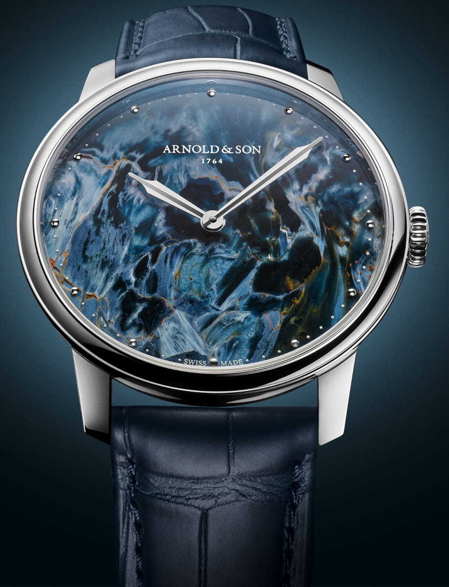 Front view of Arnold&Son HM Pietersite wristwatch with stainless steel case, Namibian pietersite dial, and ink blue alligator leather strap.