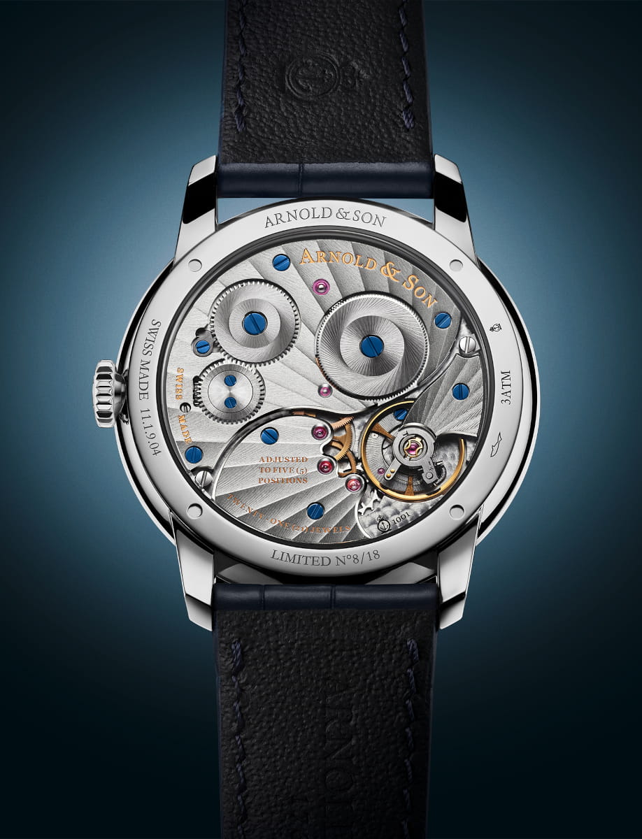 Back view of Arnold&Son HM Pietersite wristwatch with stainless steel case, sapphire crystal case back, and ink blue alligator leather strap.
